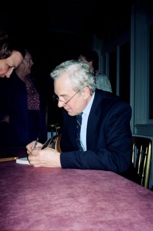 Author signing book at Dartmouth House launch