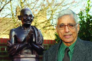 Rajmohan Gandhi by a statue of his grandfather during a visit to Hull
